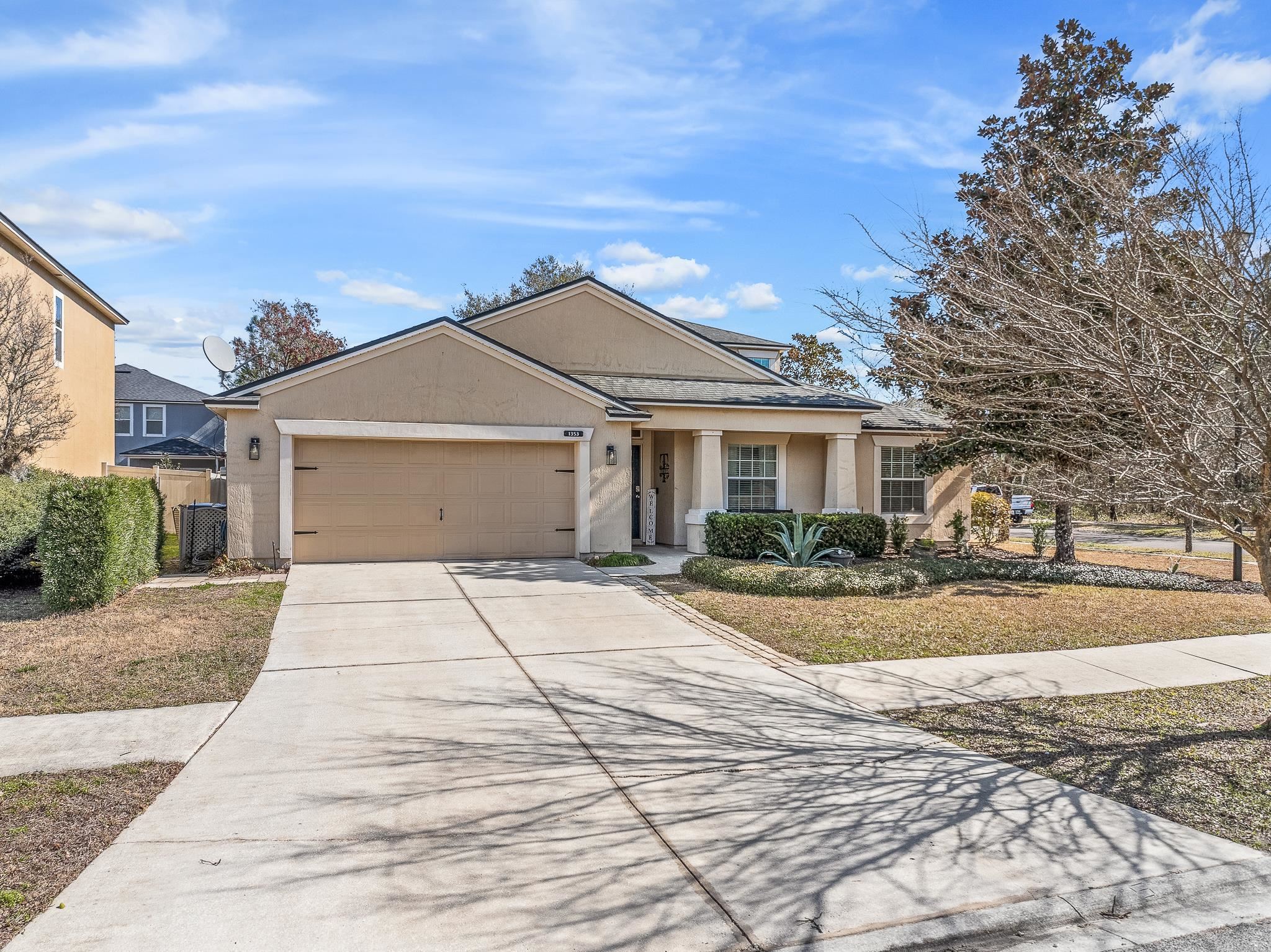 1353 Camp Ridge Lane Middleburg, FL 32068 - Photo 74 of 88 View of front of home featuring stucco siding, a garage, and driveway