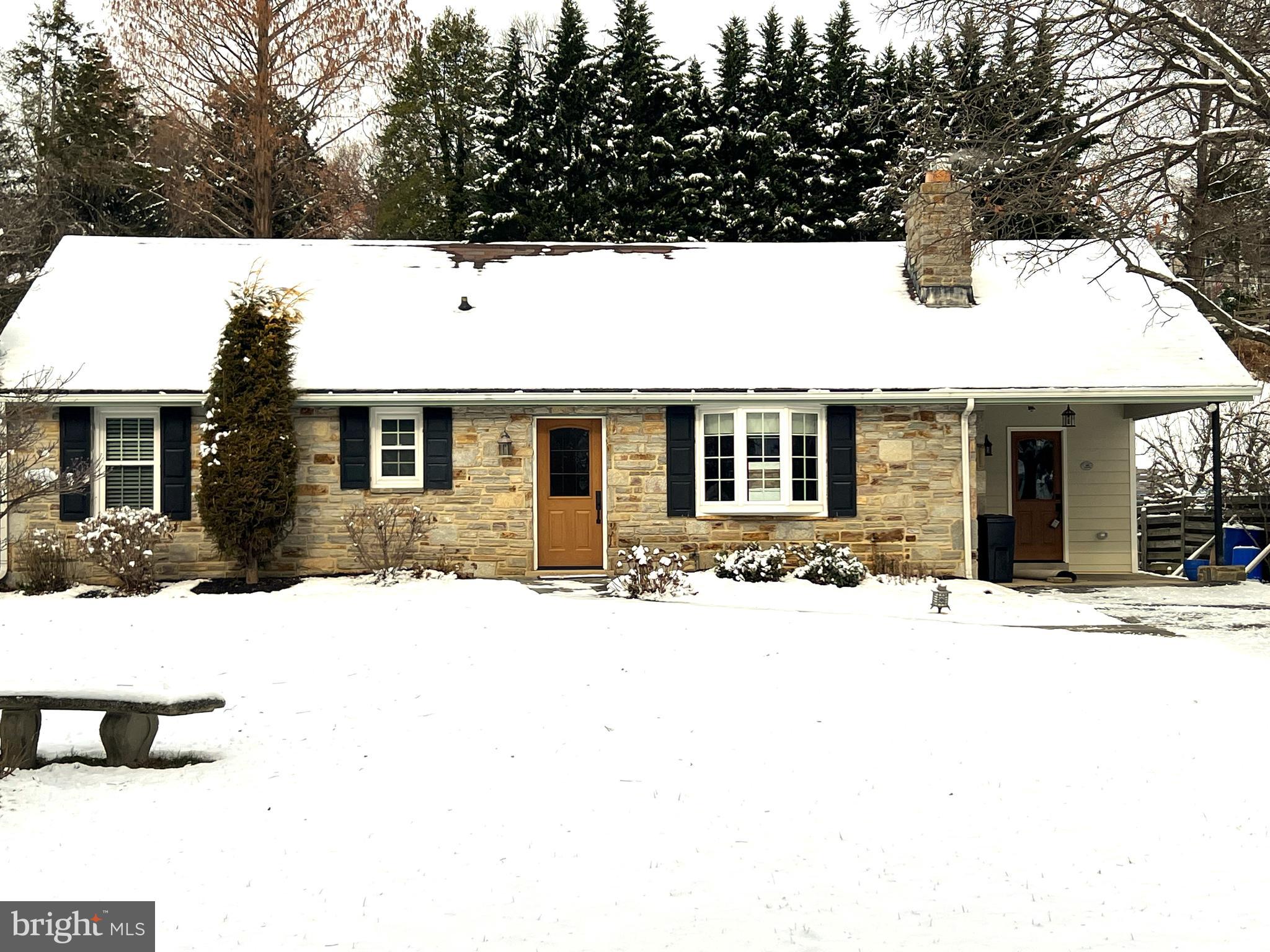 a view of house with snow on the side of road