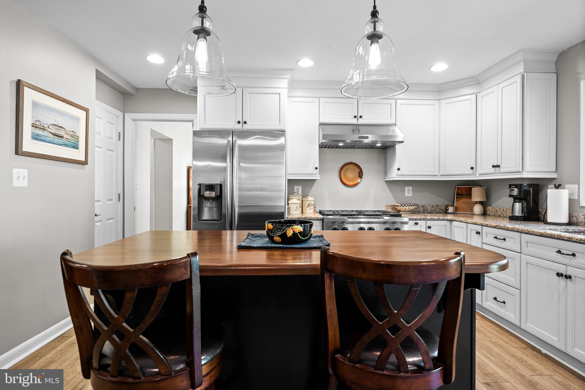 1806 Roland Avenue Ruxton, MD 21204 - Photo 12 of 43 a kitchen with a stove a refrigerator and a dining table