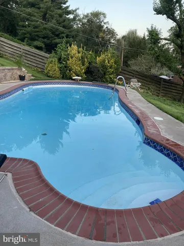 a view of a swimming pool with a yard