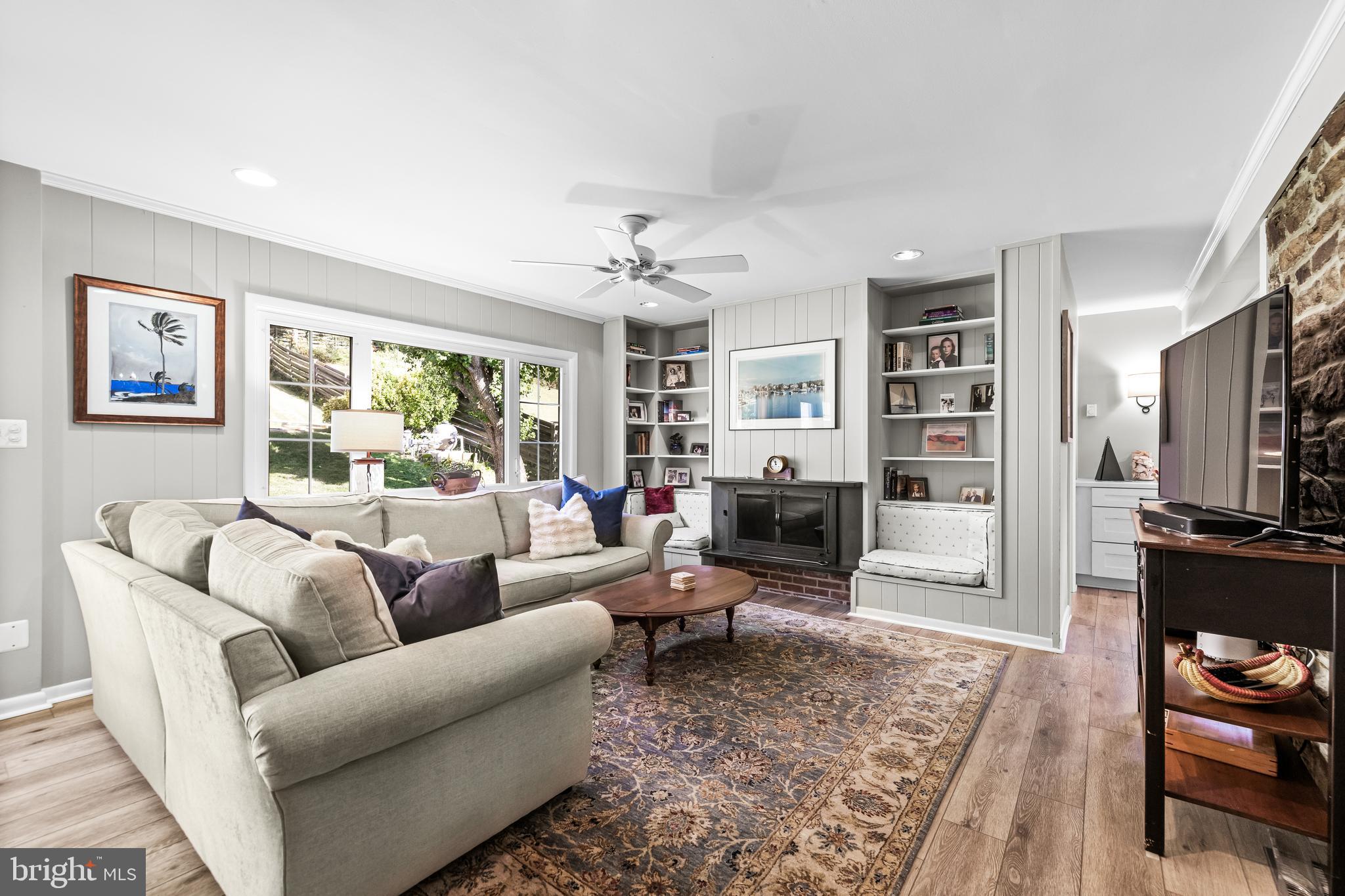 1806 Roland Avenue Ruxton, MD 21204 - Photo 17 of 43 a living room with furniture flat screen tv and a fireplace