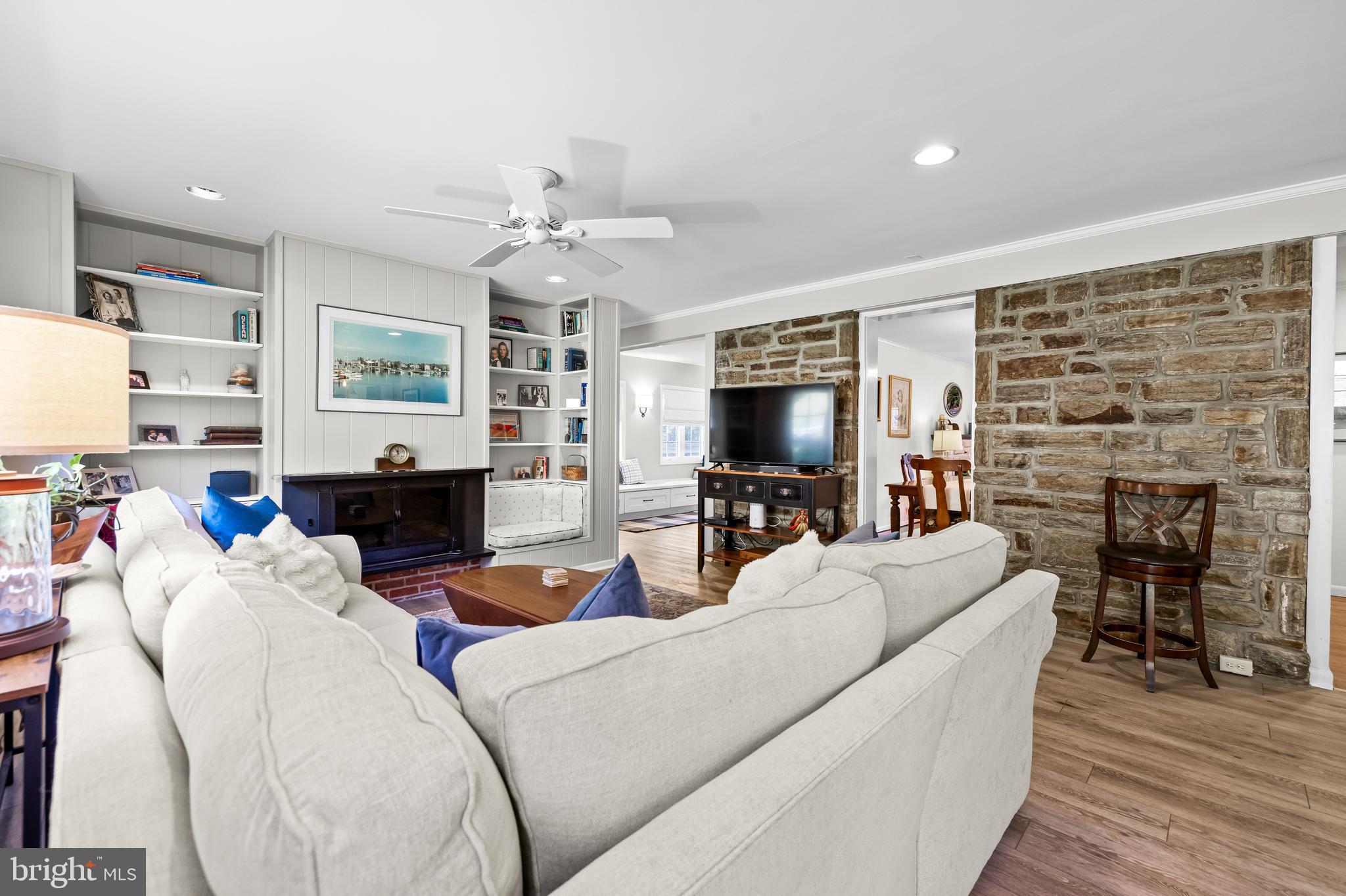 1806 Roland Avenue Ruxton, MD 21204 - Photo 18 of 43 a living room with furniture a fireplace and a flat screen tv
