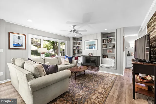 a living room with furniture flat screen tv and a fireplace