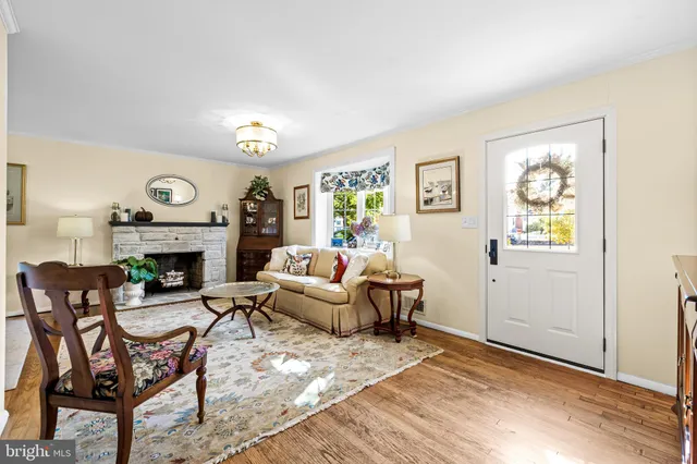 a living room with furniture a fireplace and a window