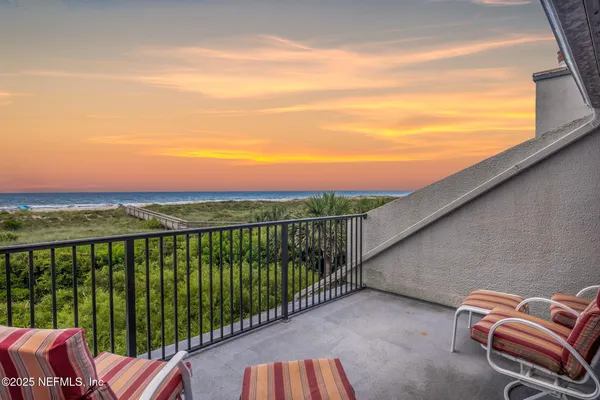 an aerial view of a house with a yard and lake view