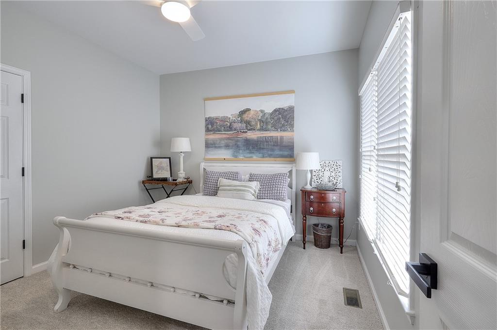 2018 Paper Birch Cove Grayson, GA 30017 - Photo 11 of 48 a bedroom with a bed and a chandelier