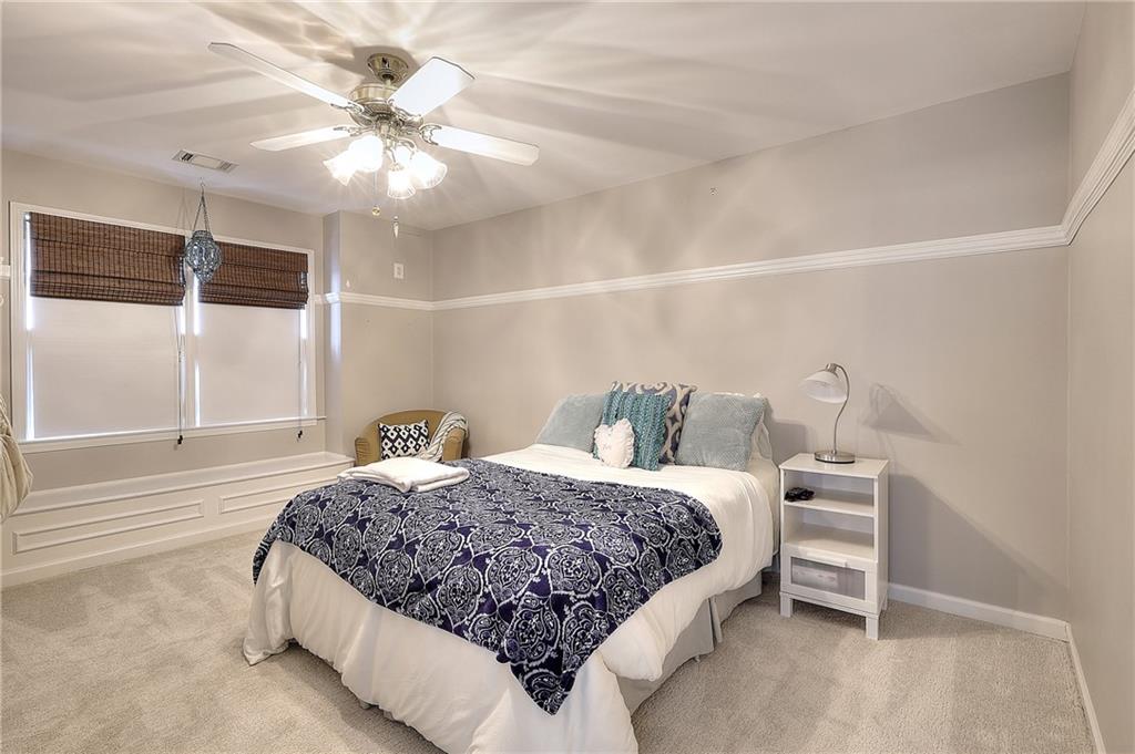 2018 Paper Birch Cove Grayson, GA 30017 - Photo 17 of 48 a bedroom with a large bed and a chandelier
