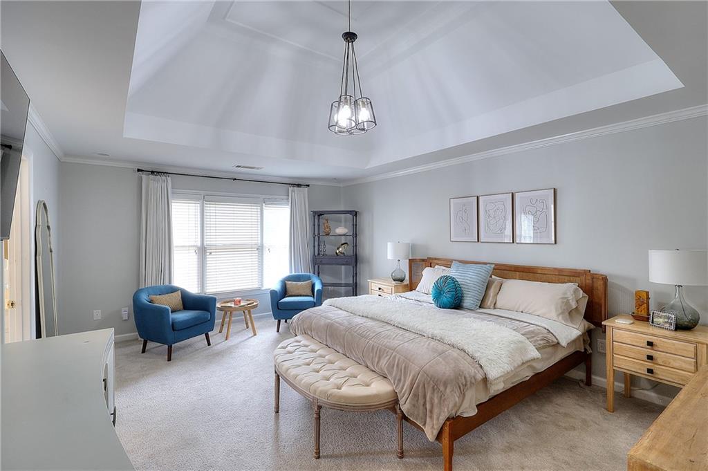 2018 Paper Birch Cove Grayson, GA 30017 - Photo 23 of 48 a bedroom with a bed and a chandelier