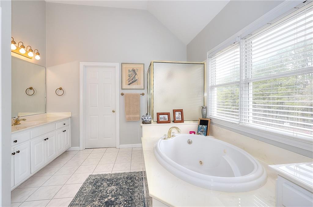 2018 Paper Birch Cove Grayson, GA 30017 - Photo 25 of 48 a bathroom with a tub sink and mirror