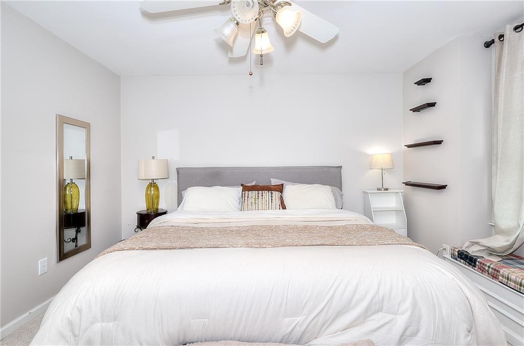 2018 Paper Birch Cove Grayson, GA 30017 - Photo 31 of 48 a bedroom with a bed and a chandelier