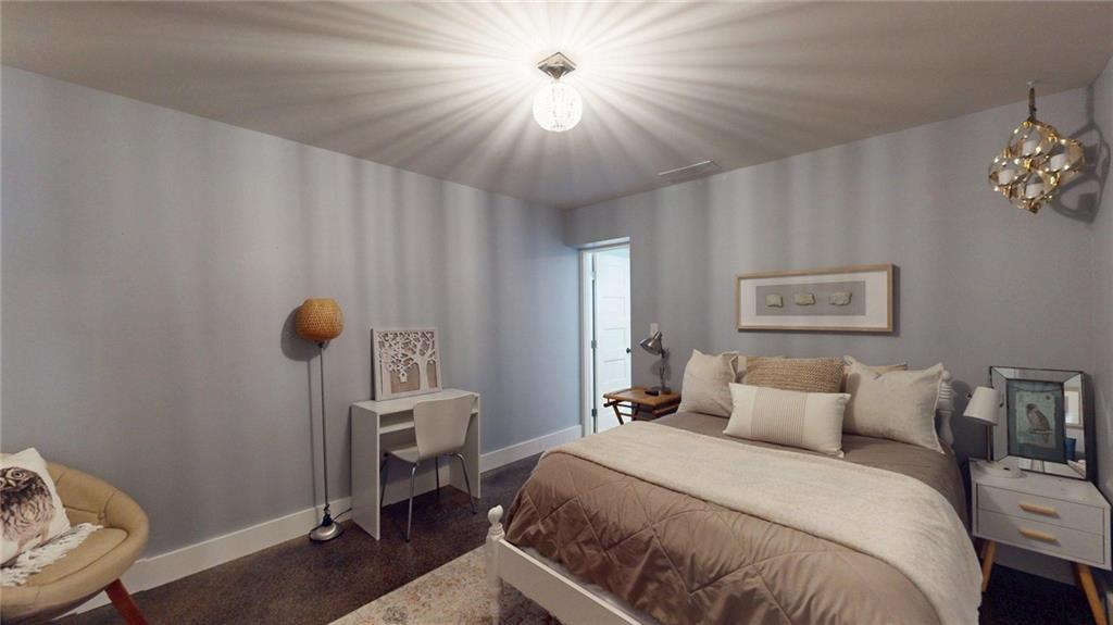 2018 Paper Birch Cove Grayson, GA 30017 - Photo 39 of 48 a bedroom with a bed and a chandelier
