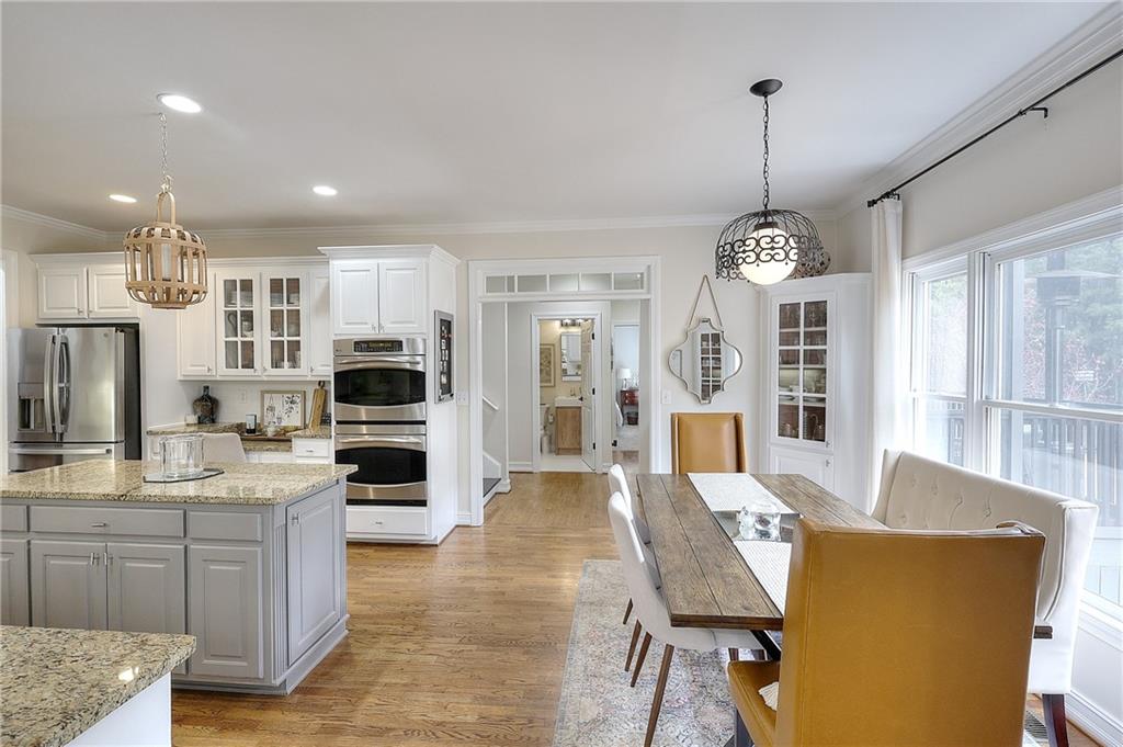 2018 Paper Birch Cove Grayson, GA 30017 - Photo 6 of 48 a view of a kitchen with kitchen island granite countertop wooden floor stainless steel appliances and windows
