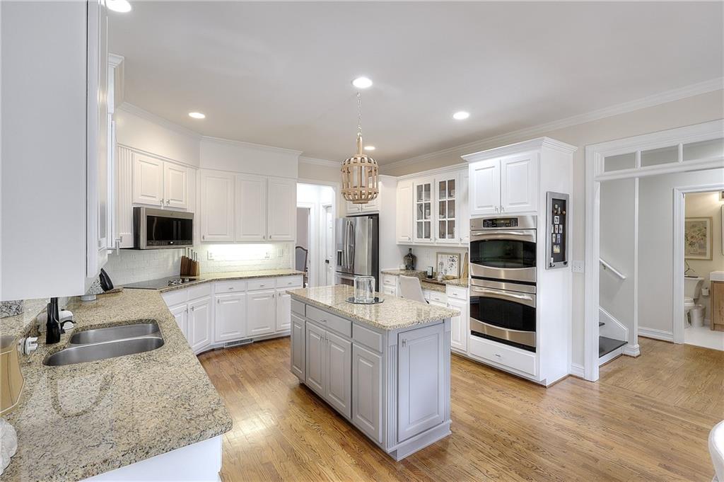 2018 Paper Birch Cove Grayson, GA 30017 - Photo 7 of 48 a kitchen with stainless steel appliances granite countertop a sink stove and refrigerator