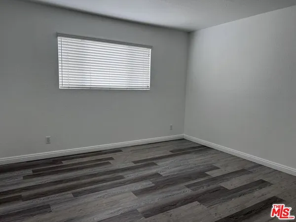 a room with a hardwood and a window