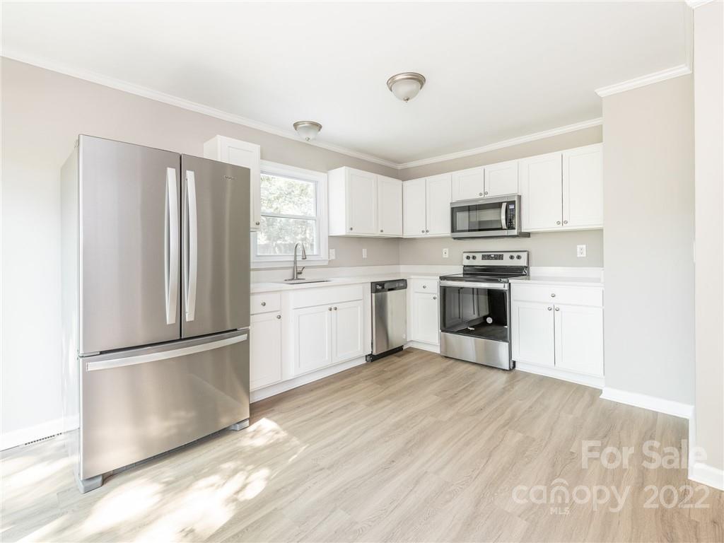 826 McAlway Road Charlotte, NC 28211 - Photo 15 of 30 a kitchen with a refrigerator a sink and a stove top oven
