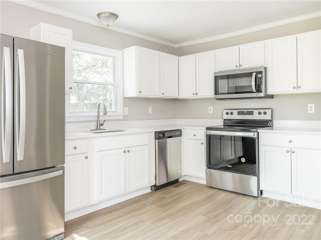 826 McAlway Road Charlotte, NC 28211 - Photo 16 of 30 a kitchen with stainless steel appliances granite countertop a stove a sink and a microwave