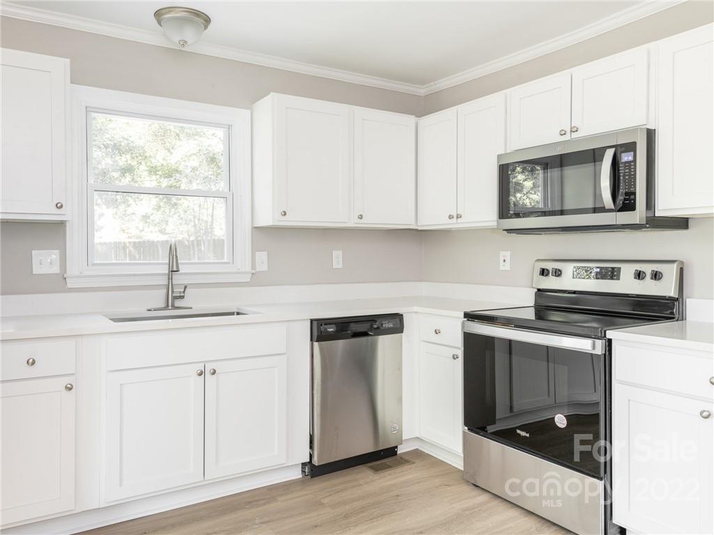 826 McAlway Road Charlotte, NC 28211 - Photo 18 of 30 a kitchen with stainless steel appliances granite countertop a stove a sink and a microwave