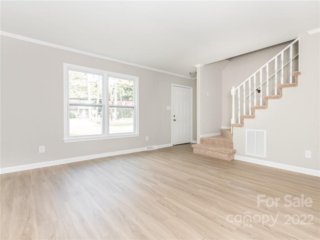 826 McAlway Road Charlotte, NC 28211 - Photo 22 of 30 a view of an empty room with wooden floor and a window