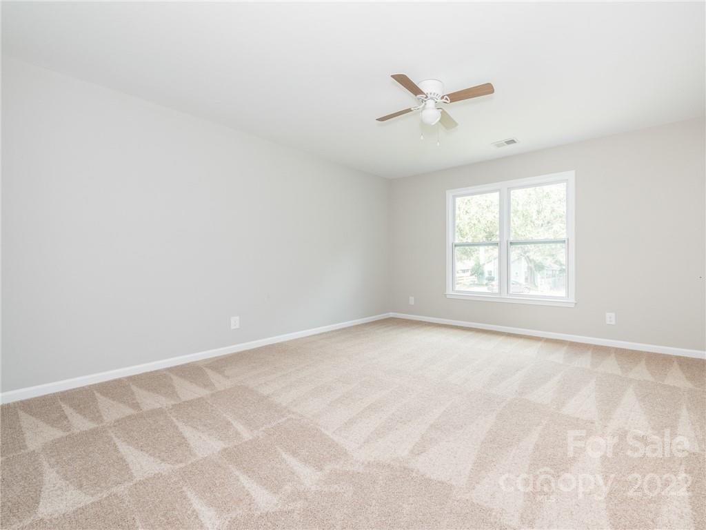 826 McAlway Road Charlotte, NC 28211 - Photo 24 of 30 an empty room with windows and fan