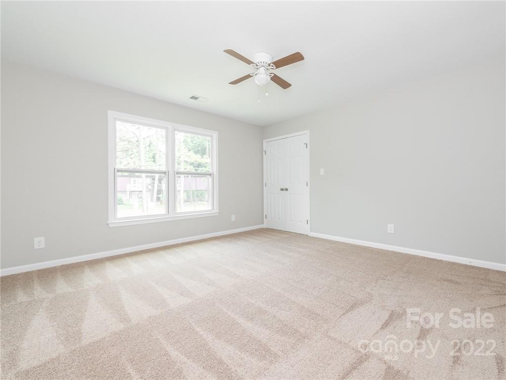 826 McAlway Road Charlotte, NC 28211 - Photo 25 of 30 an empty room with windows and fan