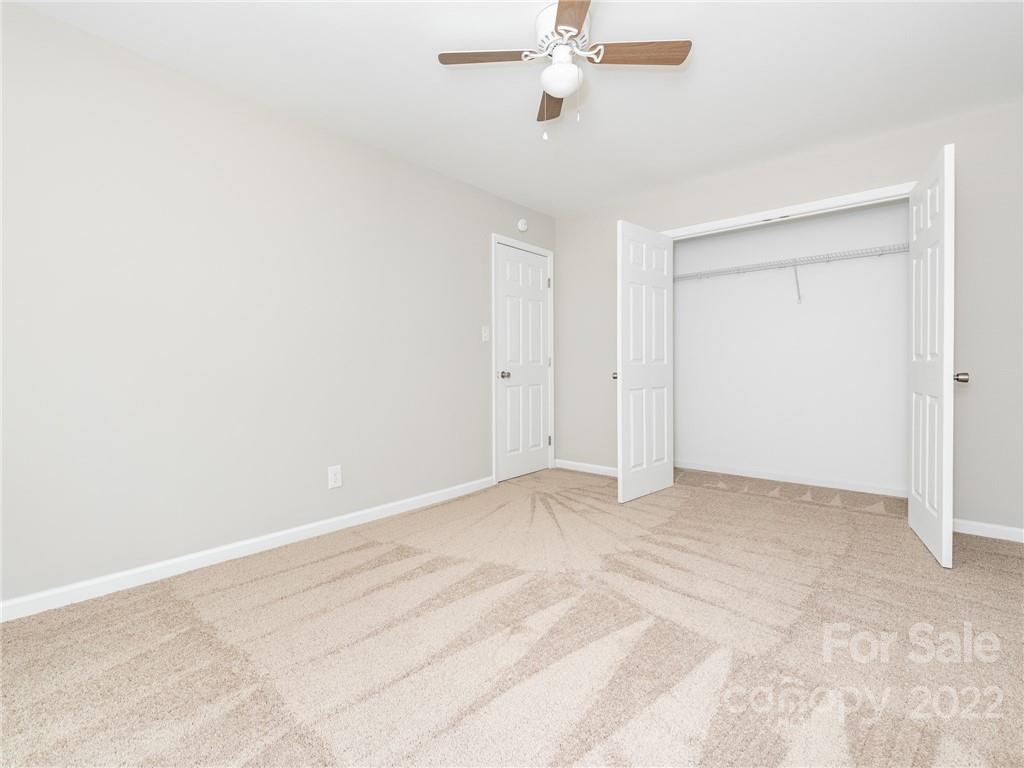 826 McAlway Road Charlotte, NC 28211 - Photo 28 of 30 a view of an empty room with a chandelier fan