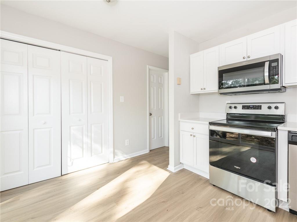 826 McAlway Road Charlotte, NC 28211 - Photo 8 of 30 a view of a kitchen with a stove cabinets and a wooden floor