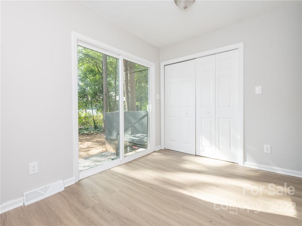 826 McAlway Road Charlotte, NC 28211 - Photo 9 of 30 a view of an empty room with wooden floor and a window