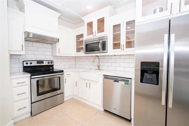 a kitchen with stainless steel appliances granite countertop a stove and a refrigerator
