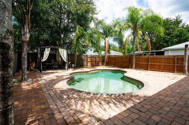 a view of a swimming pool with a backyard
