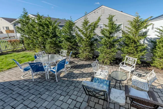 a sign that is sitting on a table in a backyard