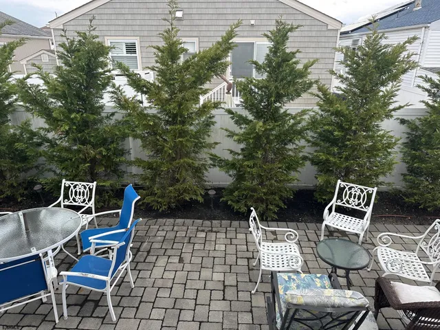 a view of a backyard with sitting area