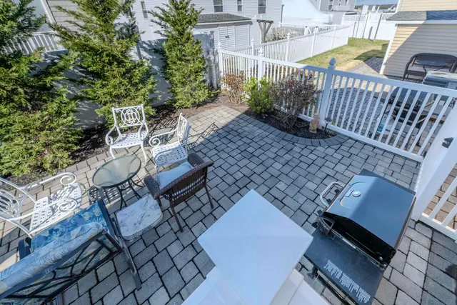 a view of a backyard with potted plants and a bench