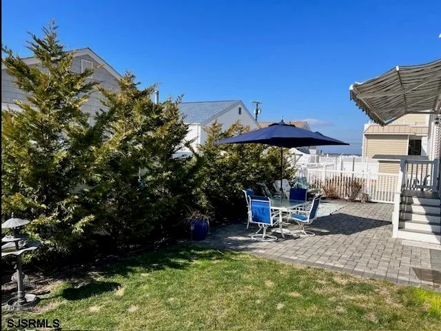 a view of a backyard with sitting area