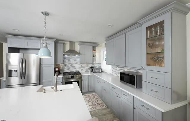 a large kitchen with a table and chairs