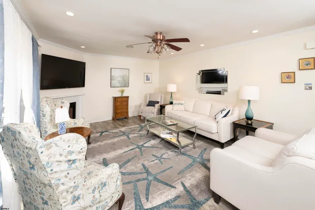 a living room with furniture a flat screen tv and a fireplace