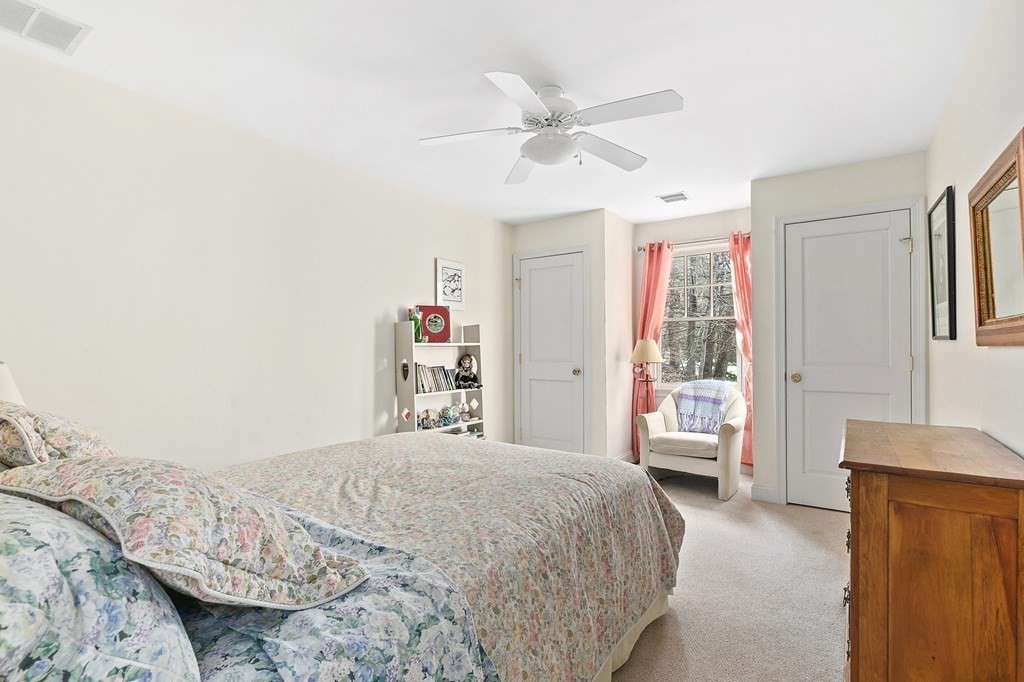 59 Crestview Road Milton, MA 02186 - Photo 15 of 32 a bedroom with a bed and a chandelier