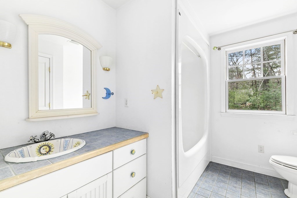 59 Crestview Road Milton, MA 02186 - Photo 17 of 32 a bathroom with a sink a toilet and a window