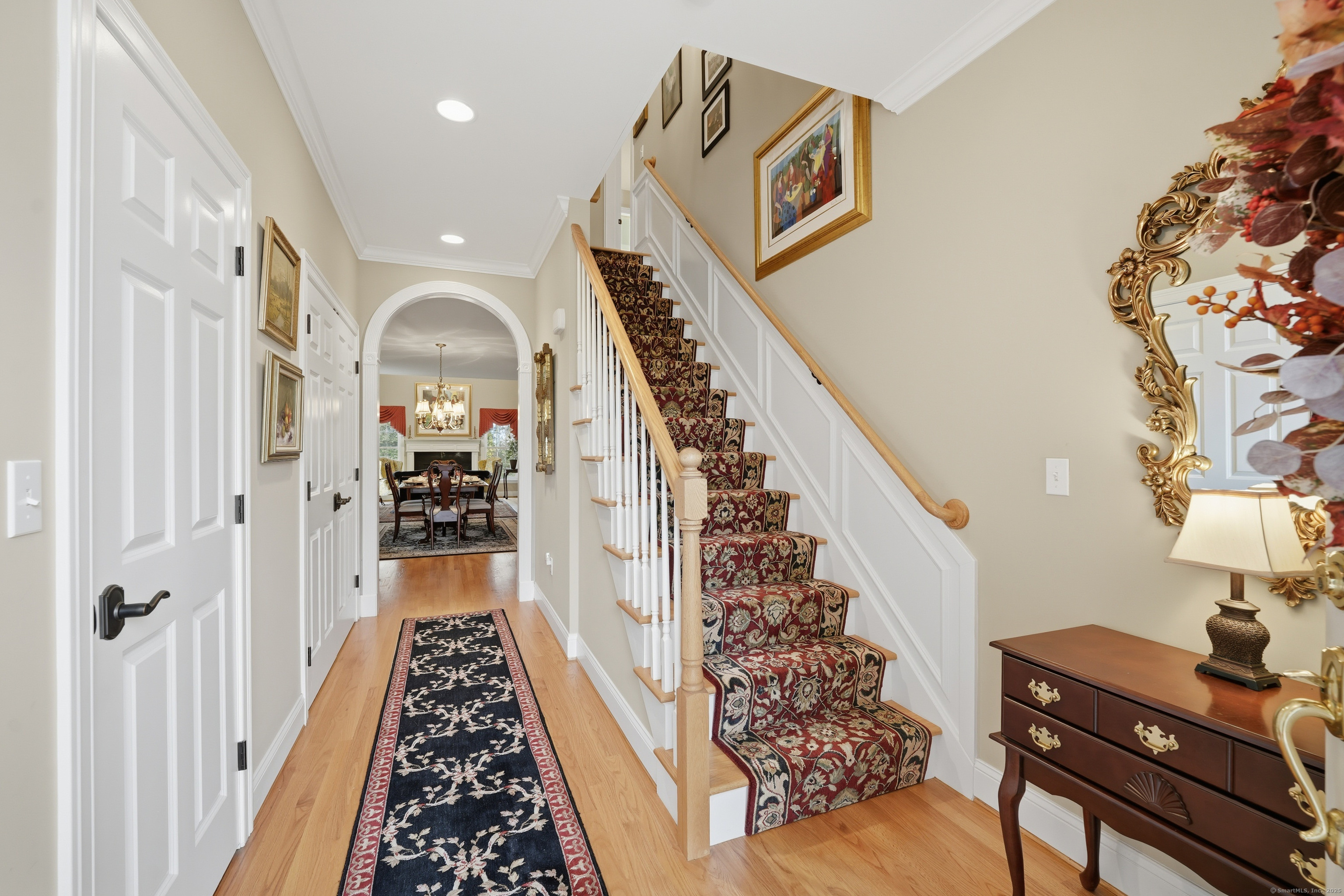 20 Greendale Drive Suffield, CT 06078 - Photo 3 of 36 a view of a hallway to a livingroom with wooden floor and stairs