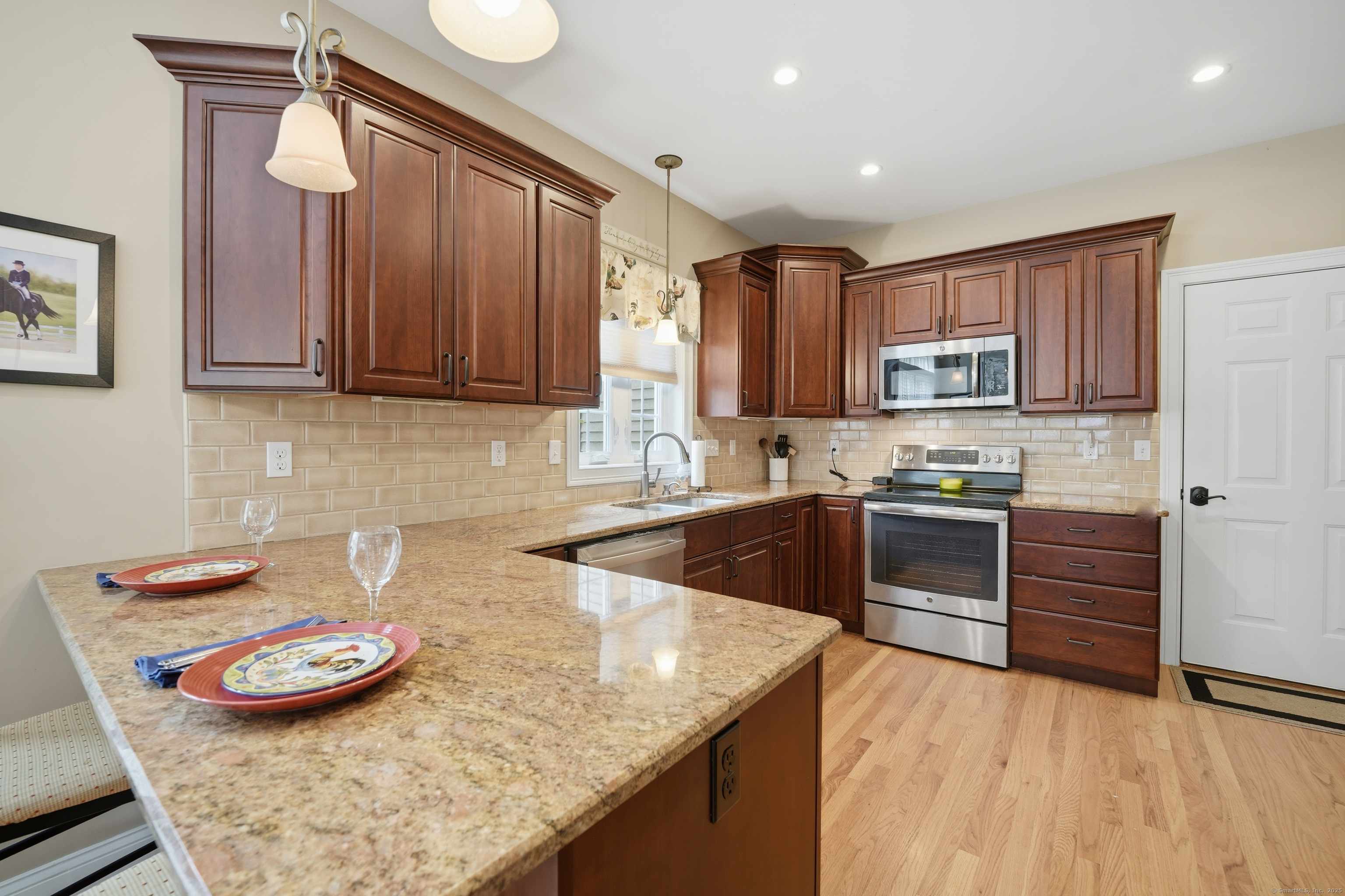 20 Greendale Drive Suffield, CT 06078 - Photo 6 of 36 a kitchen with stainless steel appliances granite countertop a stove a sink and a microwave