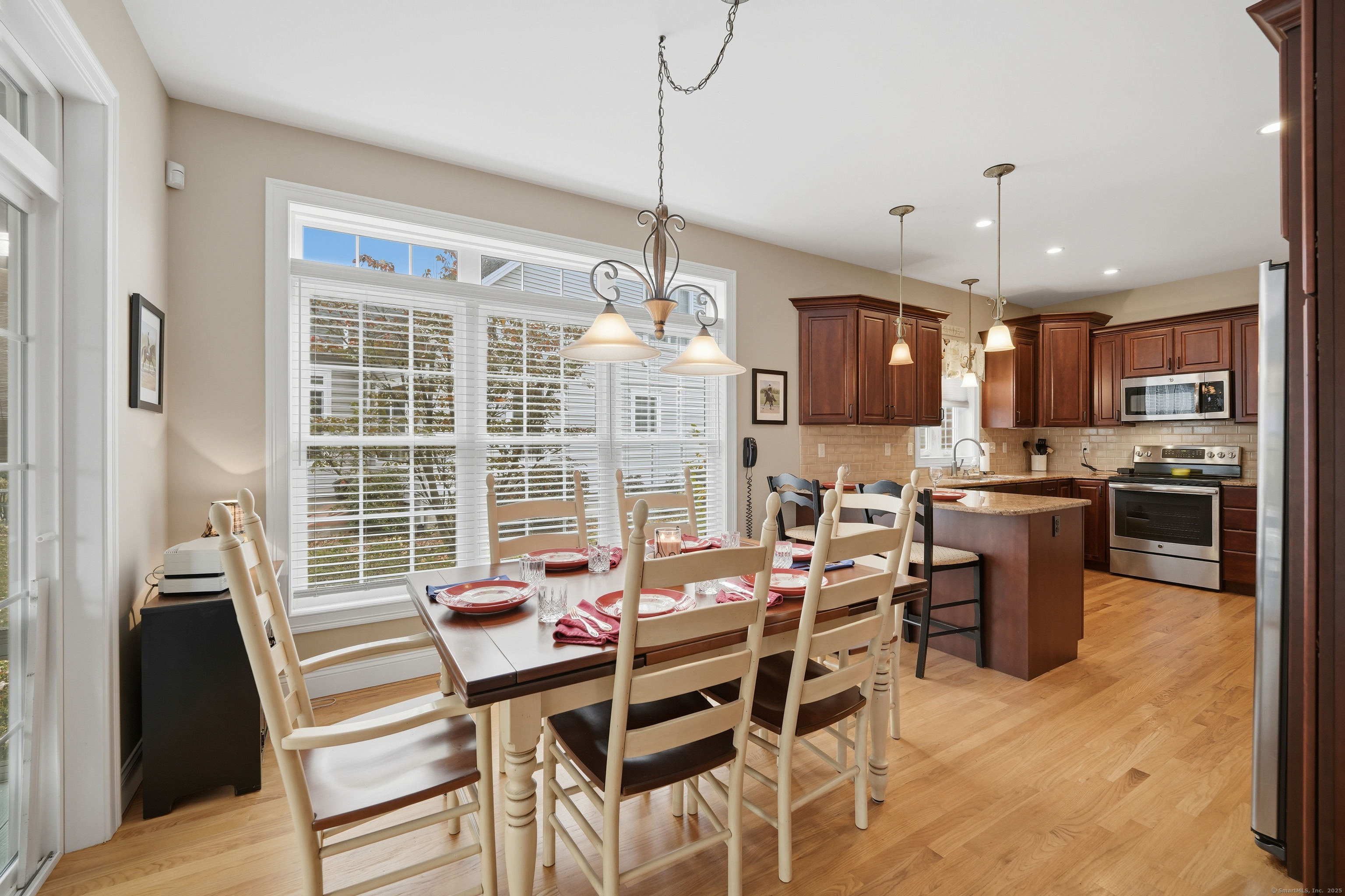 20 Greendale Drive Suffield, CT 06078 - Photo 7 of 36 a view of a dining room and livingroom with furniture wooden floor a chandelier