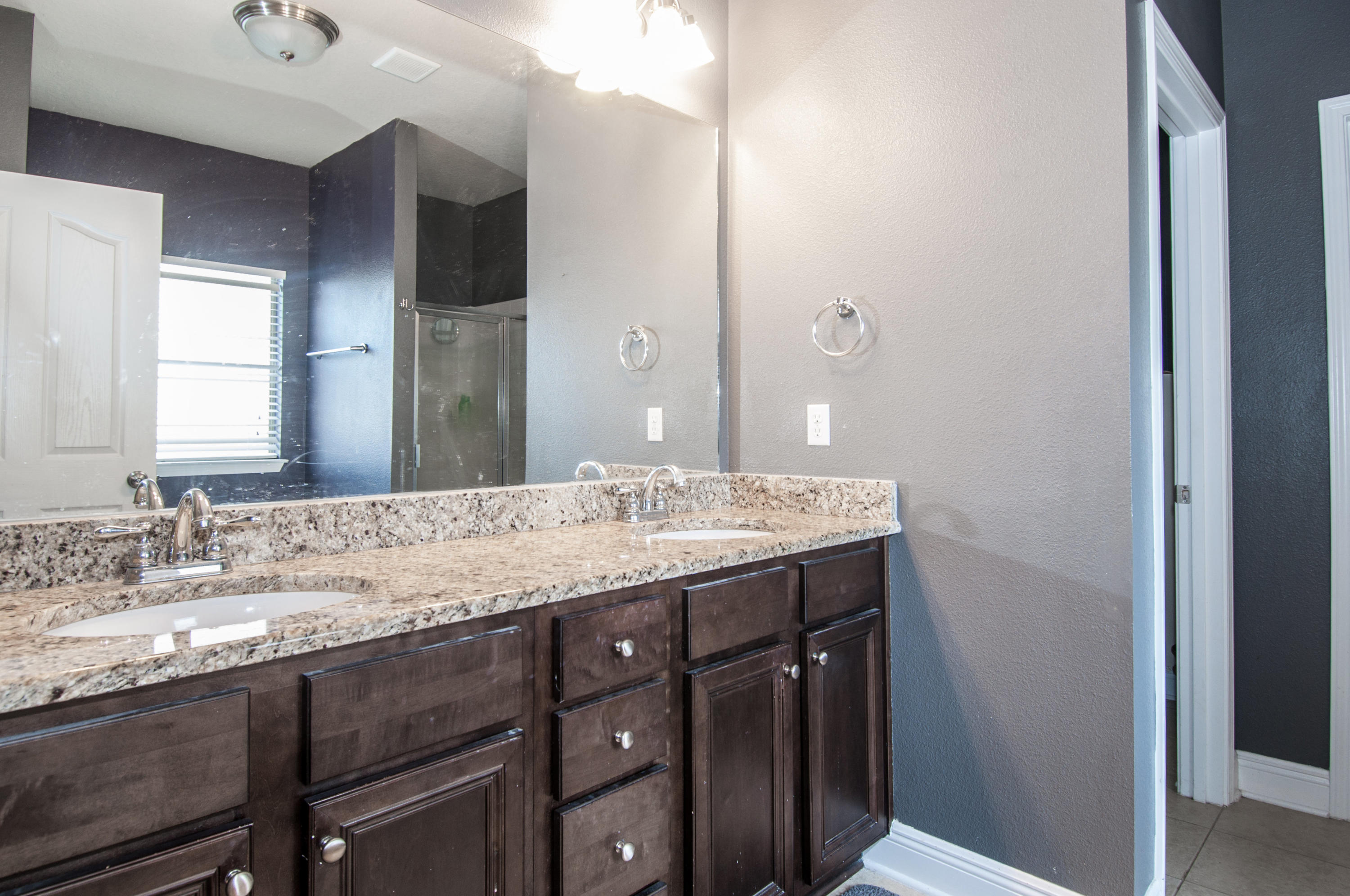 93 Mango Lane Freeport, FL 32439 - Photo 35 of 45 a bathroom with a granite countertop sink and a mirror