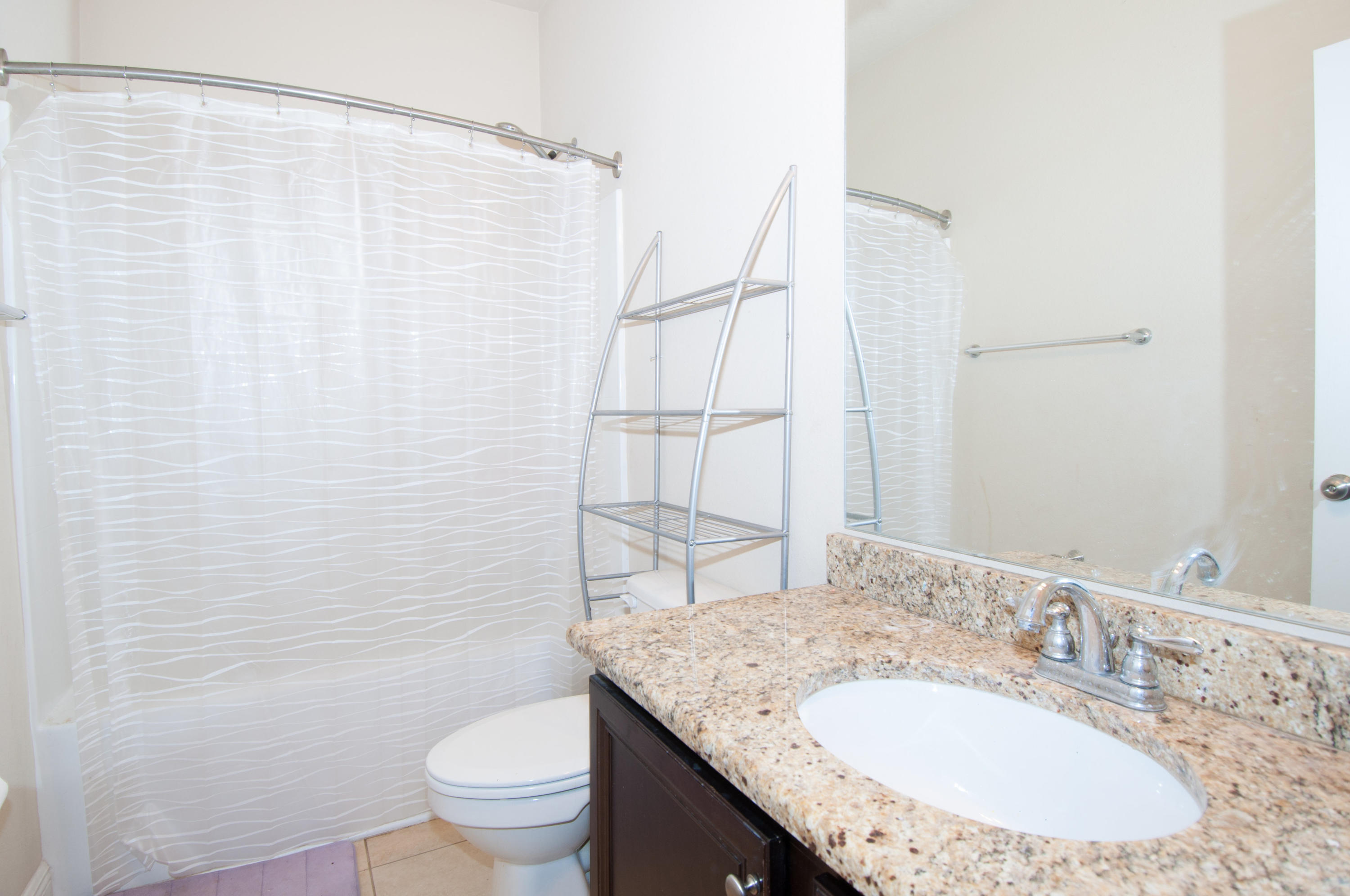 93 Mango Lane Freeport, FL 32439 - Photo 39 of 45 a bathroom with a granite countertop sink and a mirror