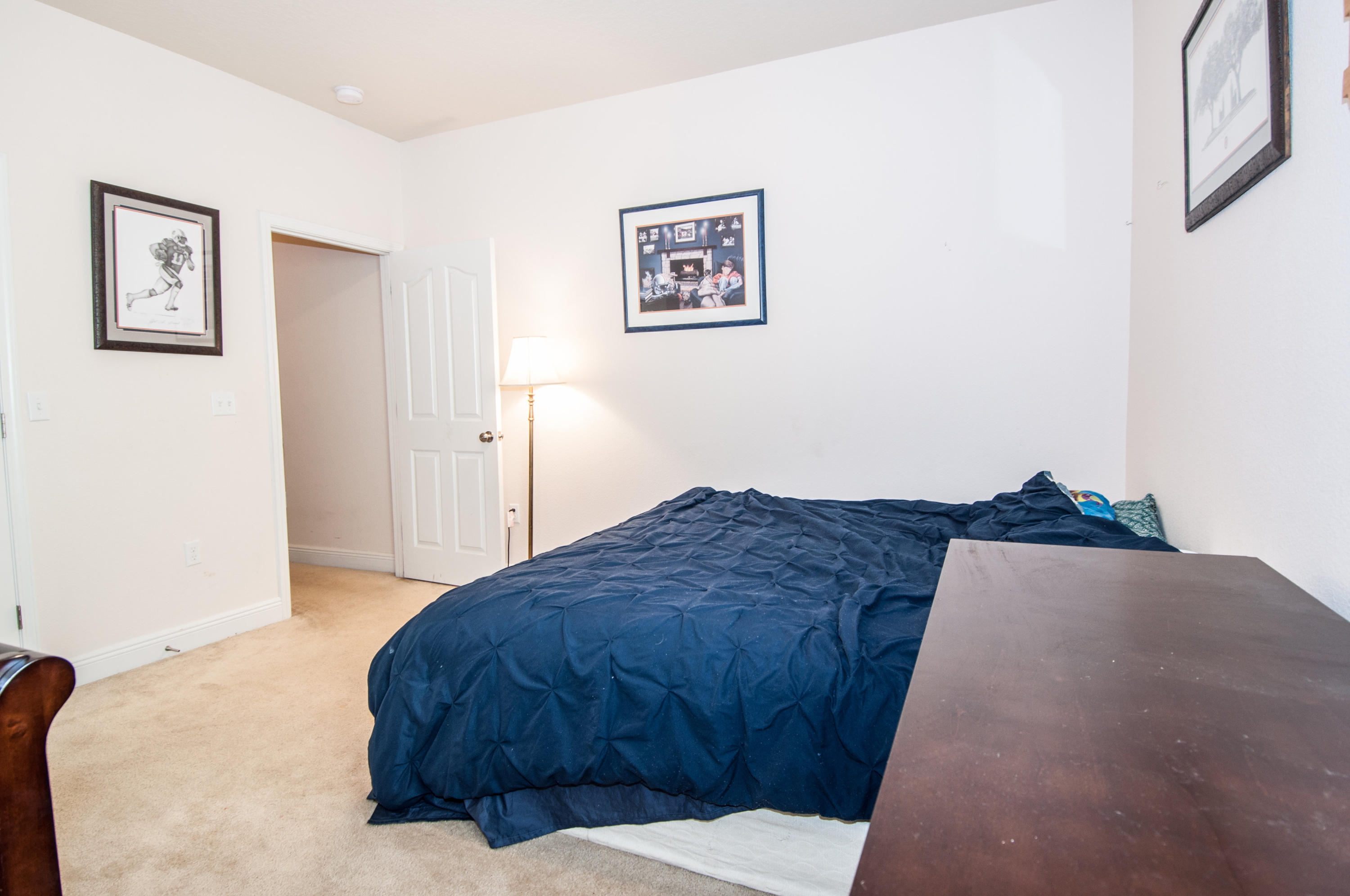 93 Mango Lane Freeport, FL 32439 - Photo 42 of 45 a bedroom with a bed and painting on the wall