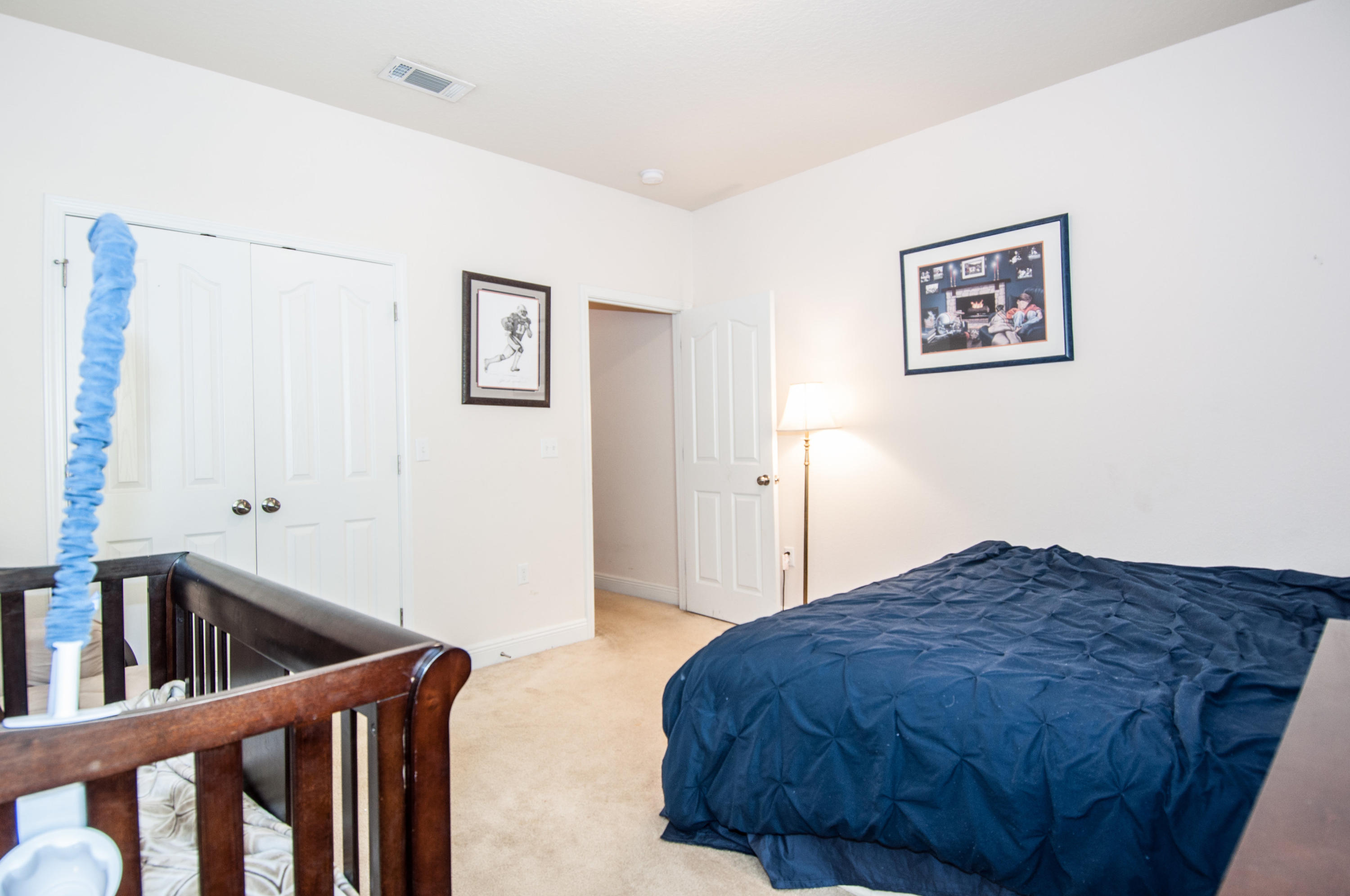 93 Mango Lane Freeport, FL 32439 - Photo 43 of 45 a bedroom with a bed and a view of kitchen