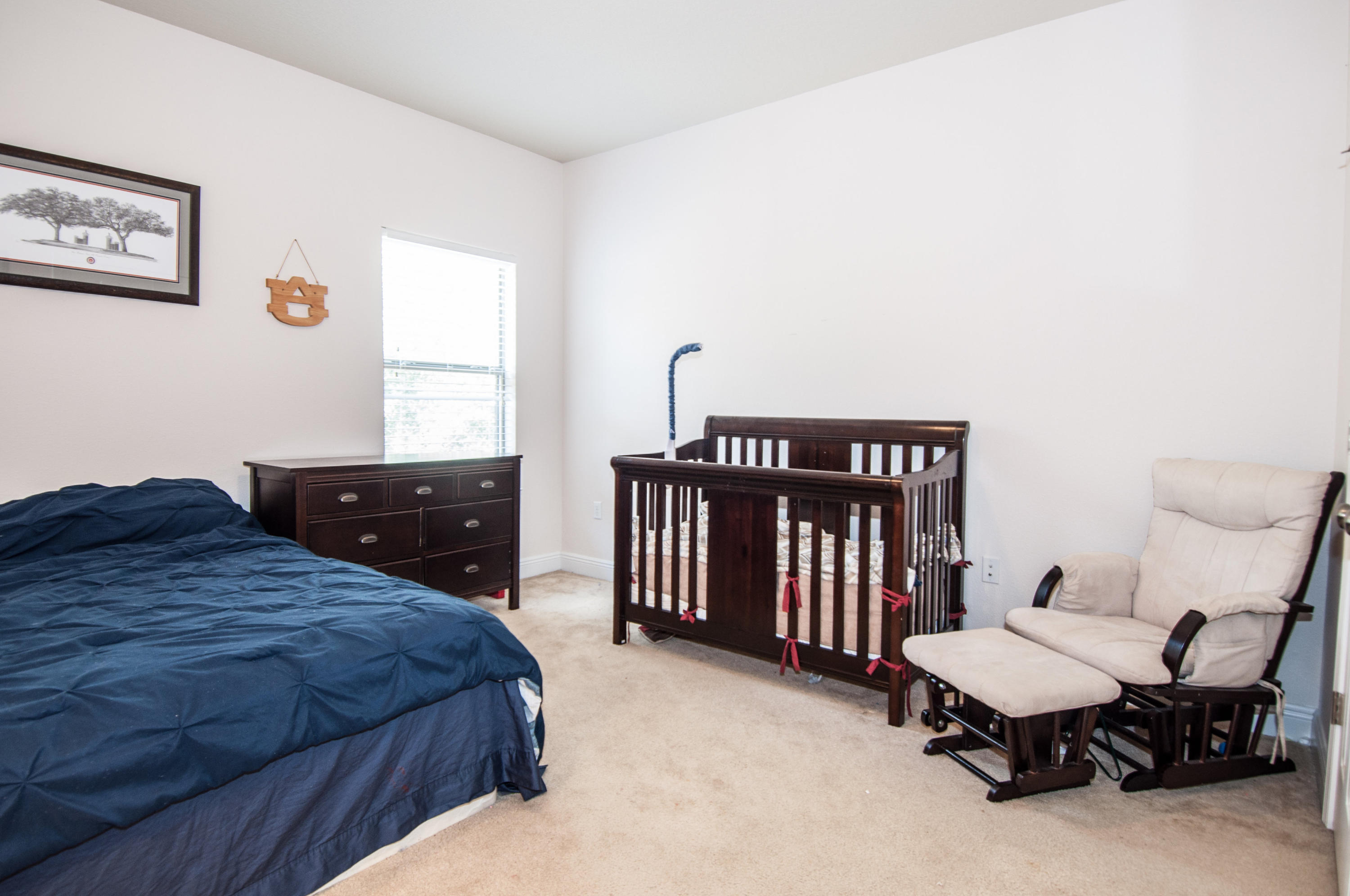 93 Mango Lane Freeport, FL 32439 - Photo 44 of 45 a bedroom with a bed and chair