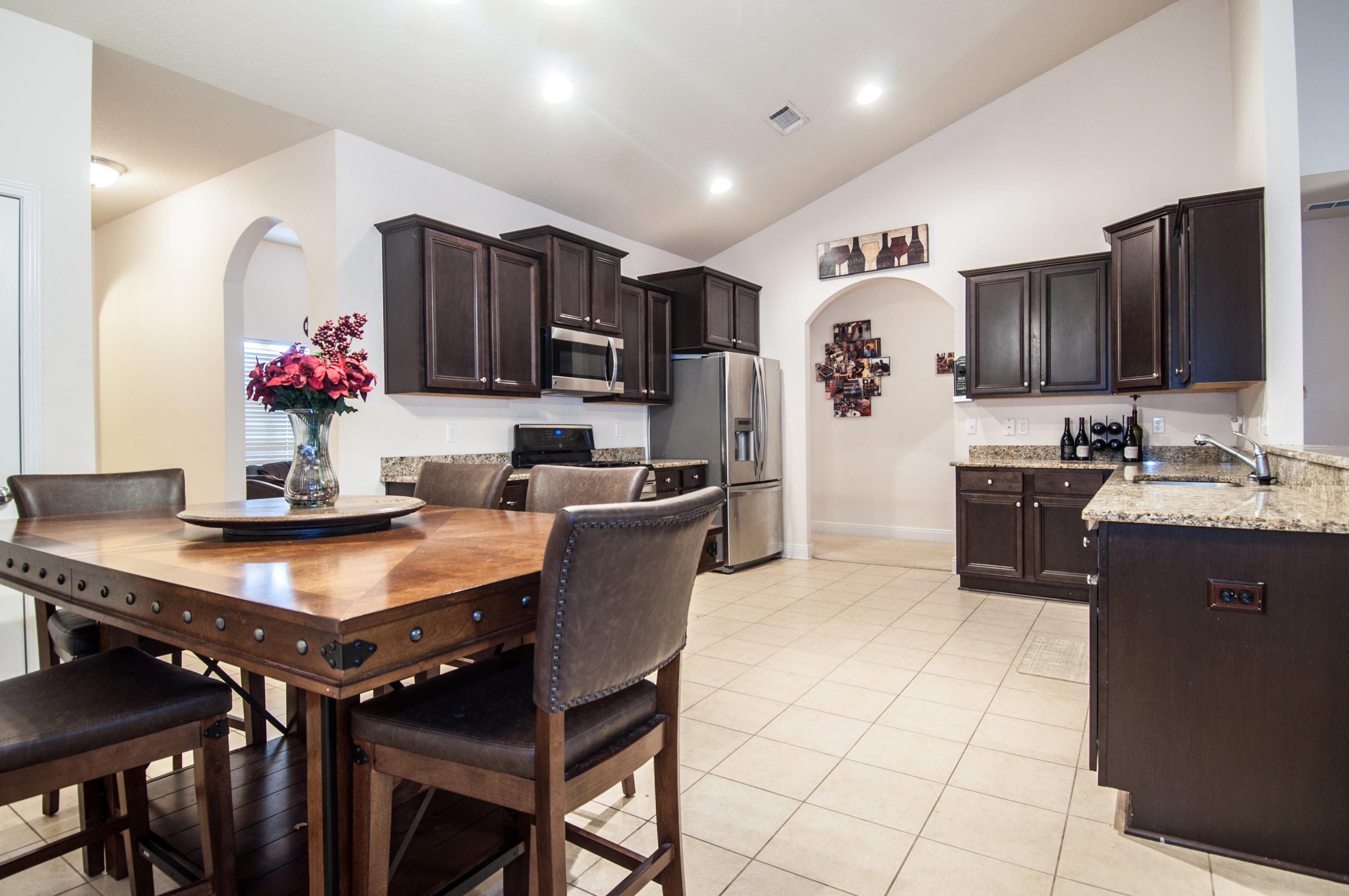 93 Mango Lane Freeport, FL 32439 - Photo 7 of 45 a kitchen with a refrigerator and a stove top oven