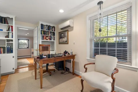 a work room with furniture and a large window