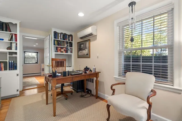 a work room with furniture and a large window