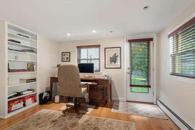 a view of a workspace with furniture and a window