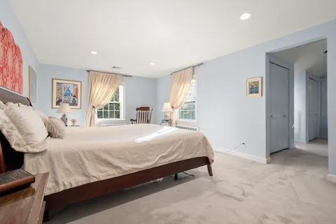 a bedroom with a large bed and a window